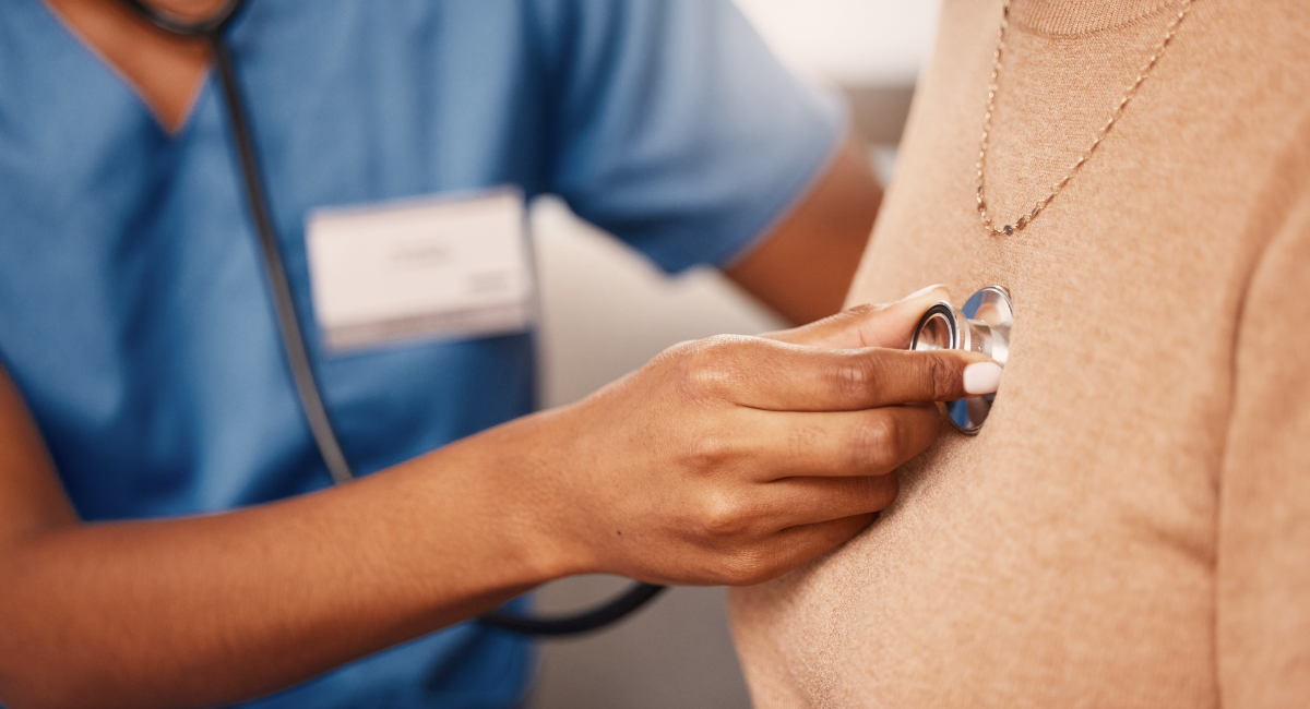 Medical professional listening to a heart beat with a stethoscope.
