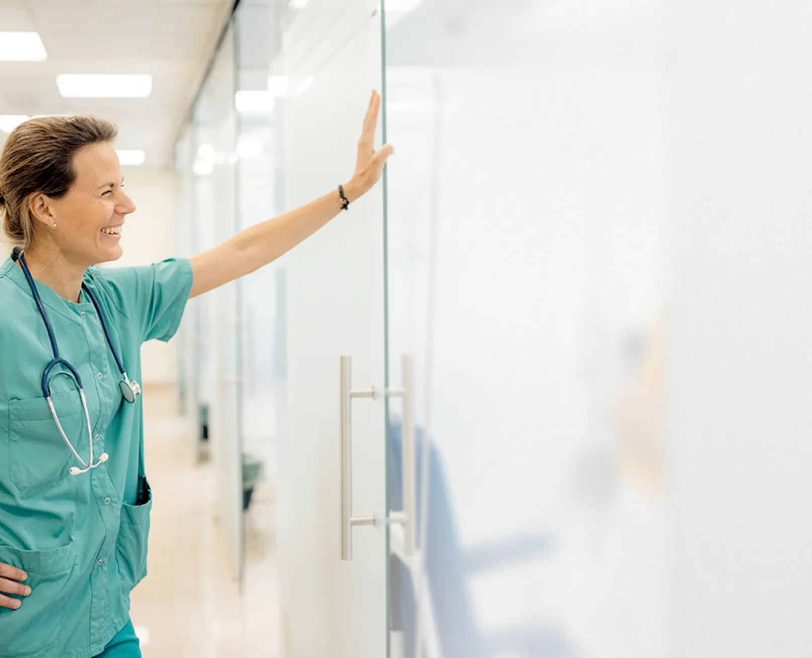 Woman in scrubs smiling
