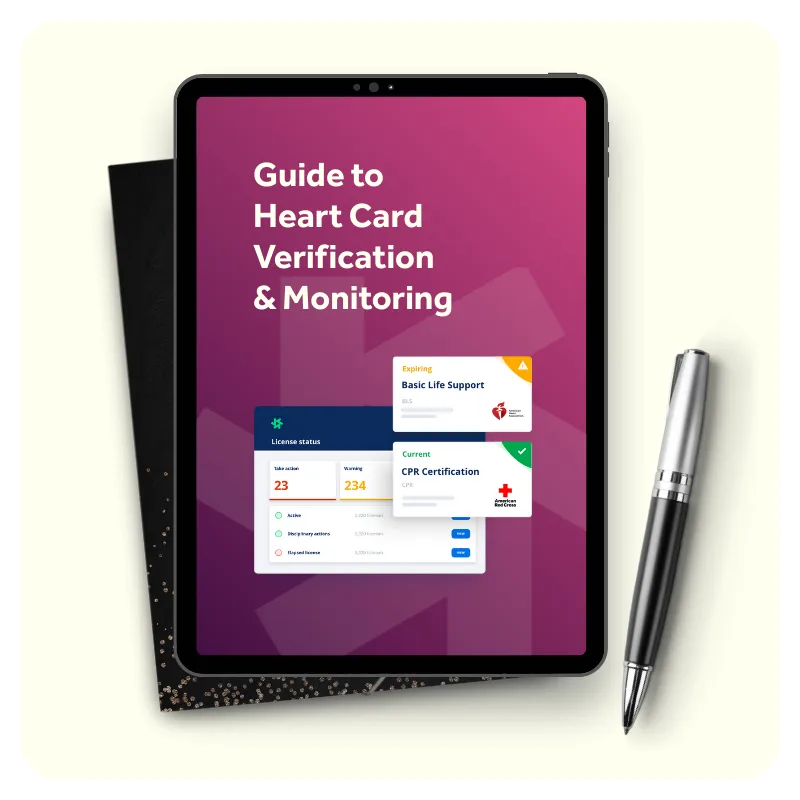 Tablet displaying a guide to heart card verification and monitoring, showing a dashboard with license status, certification cards including Basic Life Support and CPR Certification from the American Red Cross, placed on a black notebook with a pen beside it