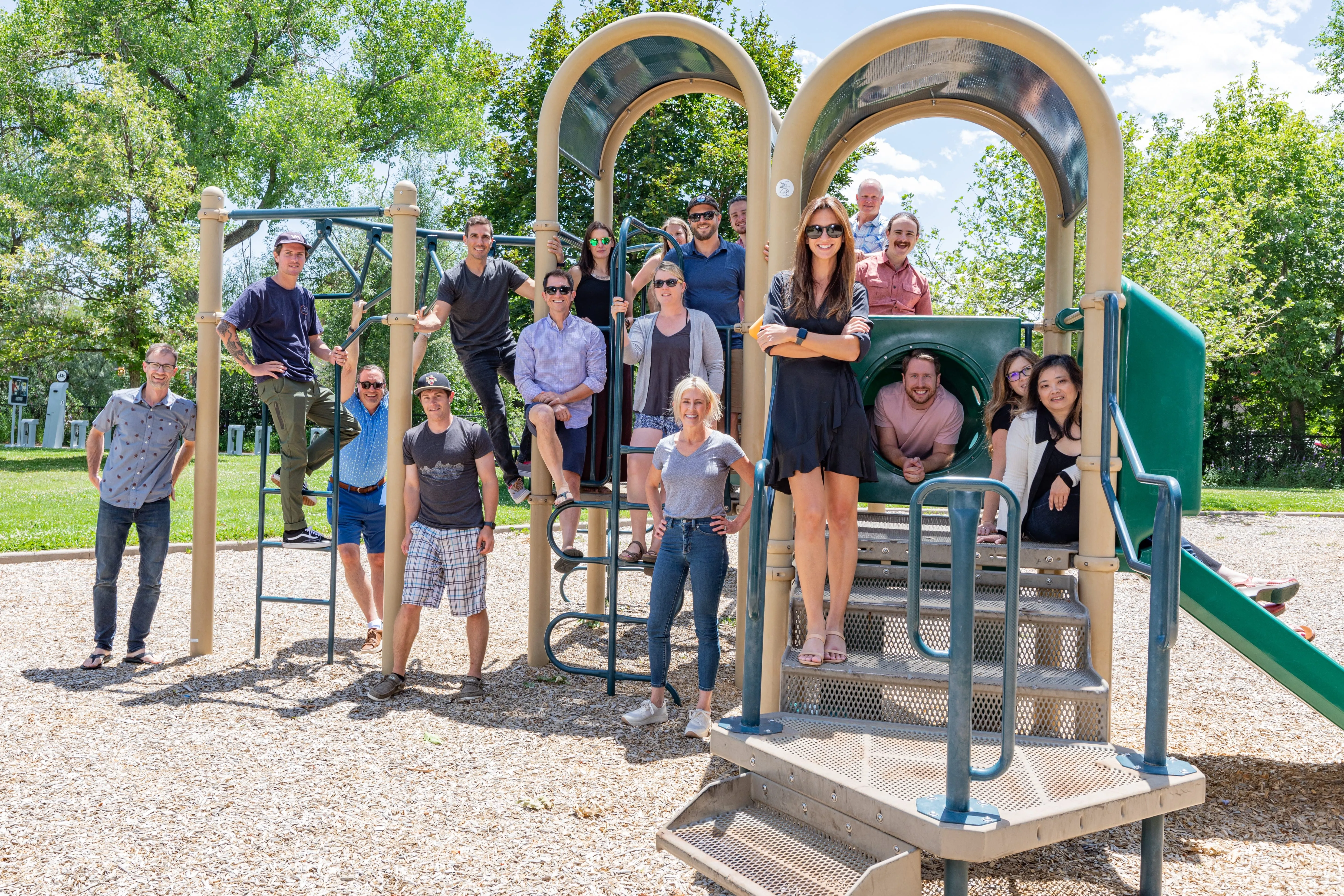 Employees smiling at a park